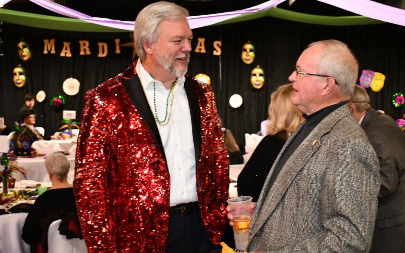 Sheriff Joey Terrell’s flamboyant red jacket clashed the color scheme a bit but was in the spirit of the night nevertheless as he converses with Brian Ausburn. MATTHEW OSBORNE/Staff