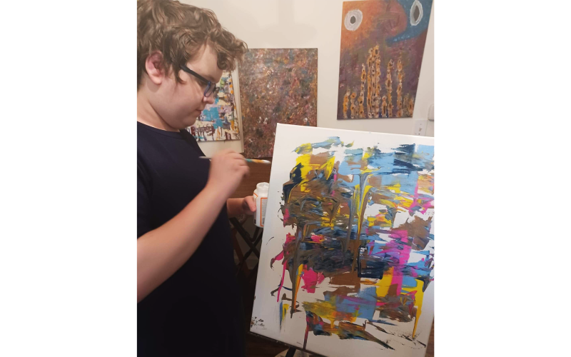 Joey Ray works on a recent rendering, the latest piece in his extensive collection of abstract paintings. SAMANTHA RAY/Submitted