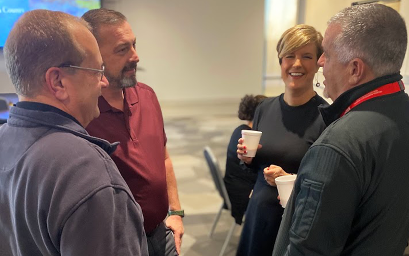 County Manager Alicia Vaughn chats with Jeff Adams, Mike Bramlett and Chad Black at a county function. CAROLYN GIBSON/Submitted