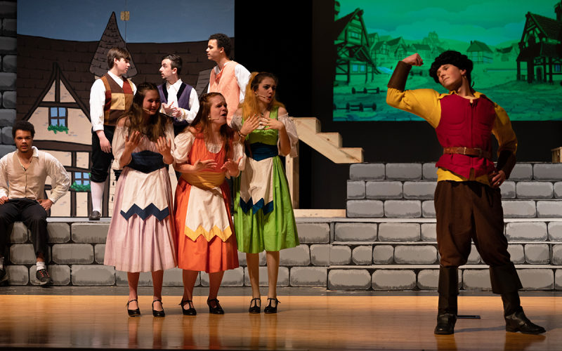 The three silly girls played by Jamie Gant, Lizzie Sanders, and Maddie Taylor are in awe of Gaston’s muscles, who is played by Nolan Penick in the show. ZACH TAYLOR/Special