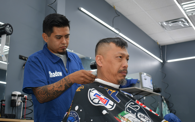 Shadow Navarrete makes all the right trimmings for Ty Kinnarath’s haircut. BRIAN WELLMEIER/Staff