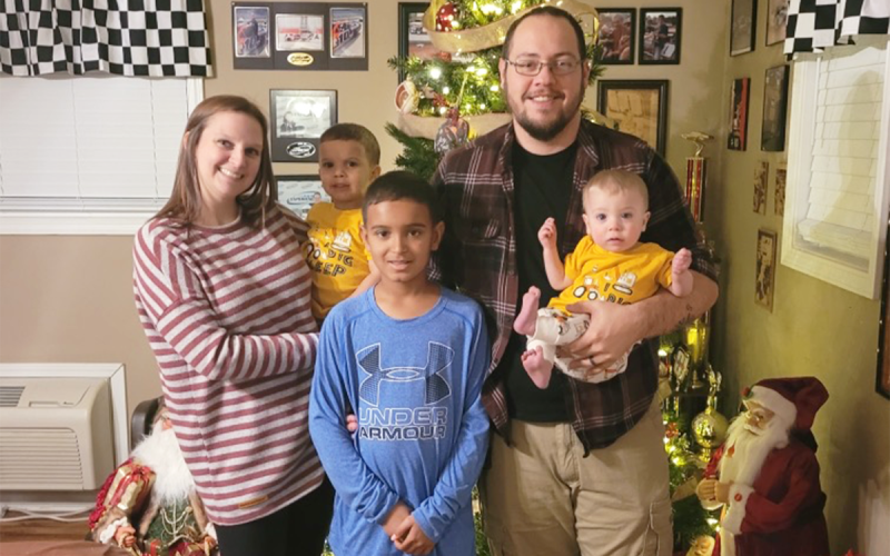 Cayla and Josh Crunkleton smile during a family holiday picture with their three sons, pictured left to right, Ayden, 2, Blake, 12, and Hudson, who will be turning 1 on April 23. SUBMITTED