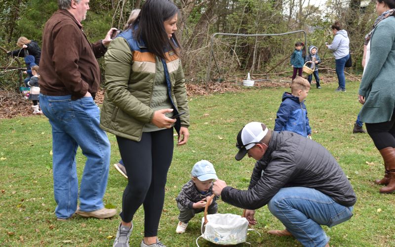 Parents help their children fill their Easter baskets with eggs during the egg hunt on Saturday at Clarkesville’s First United Methodist Church. AMARIS E. RODRIGUEZ/Staff