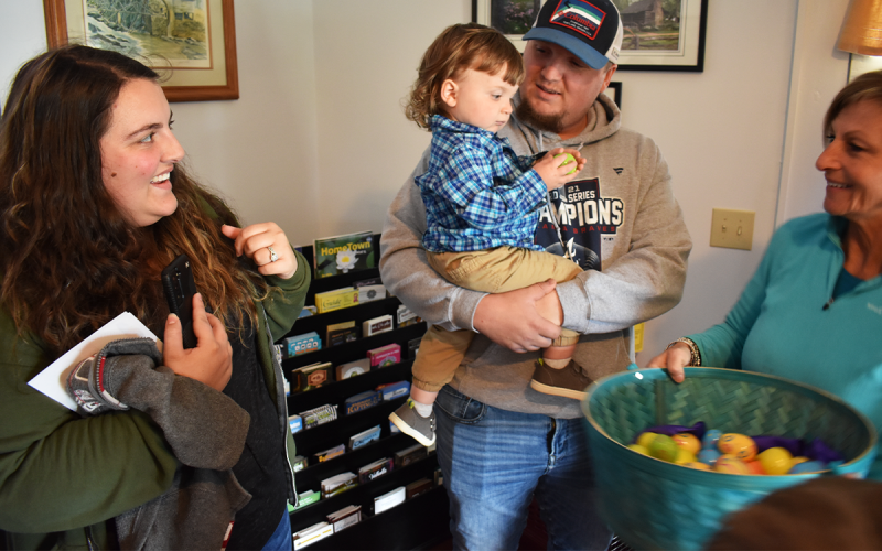 Ashley and Cagan Powell look on with big smiles as their 1-year-old, Wyatt, picks out an  Easter egg at the Mauldin House Gardens in Clarkesville on Saturday. AMARIS E. RODRIGUEZ/Staff