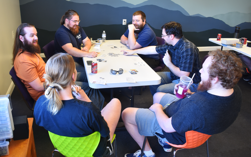 A group of friends enjoys their time playing Coup at The Games Alliance in Clarkesville. AMARIS E. RODRIGUEZ/Staff