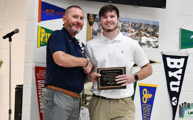 Ryan Jones (right)  received the Jimmy  Williams Courage Award on Thursday night after bouncing back from a serious injury to contribute on the field. He got his award from Raiders coach Benji Harrison. MATTHEW OSBORNE/Staff