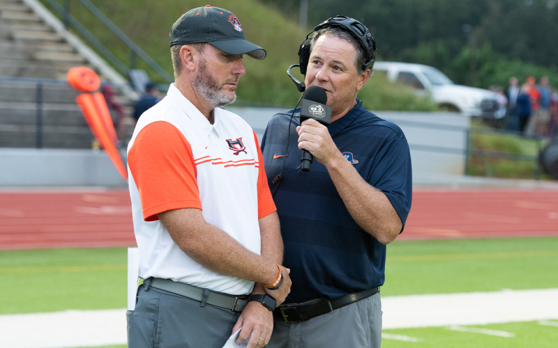 Chris Black (right) gets an interview with Raiders coach Benji Harrison before a big game. Black has been on WCON Radio for 31 years. TOM ASKEW/Special