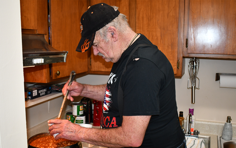 Butch Munsey serves up Brunswick stew for the to-go plates given out at the facility. MATTHEW OSBORNE/Staff