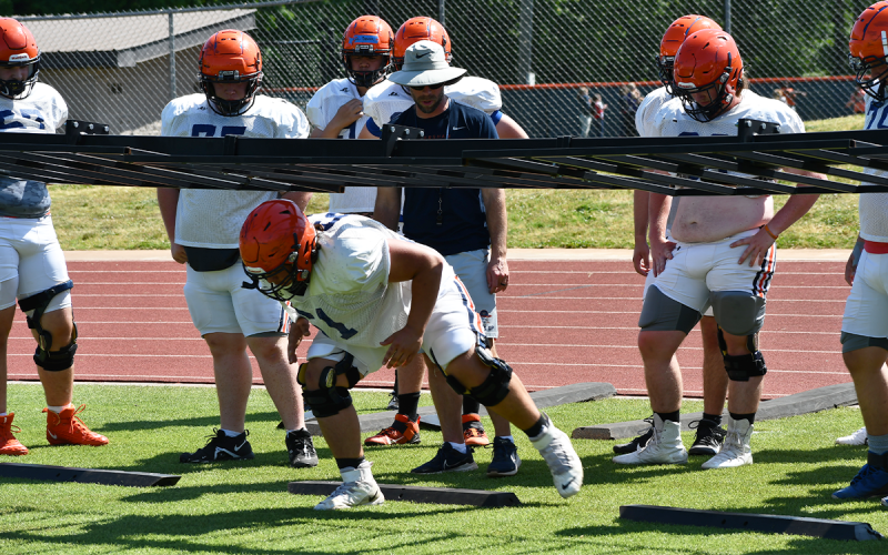 Habersham Central assistant coach Tip Johnson works with linemen Wednesday as rising senior Eddie Jenkins demonstrates proper technique to his teammates. MATTHEW OSBORNE/Staff