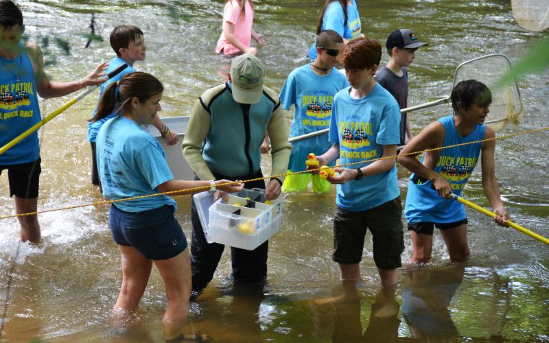 Scouts from Troop 5 fish rubber ducks out of the Soque River during last year’s race.