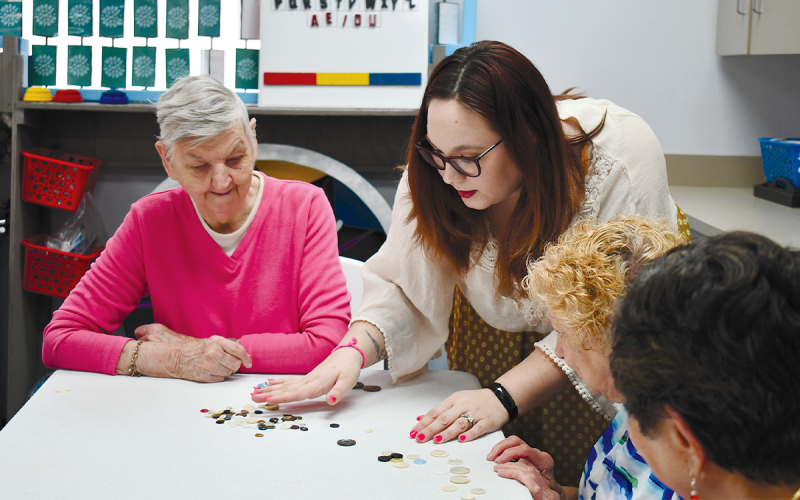 Courtney Underwood assist seniors with crafts at the Senior Center on Monday afternoon. BRIAN WELLMEIER/Staff