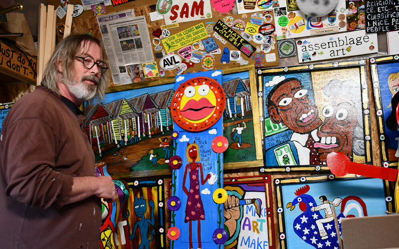 Sam Granger looks over a collection of his art in his studio. BRIAN WELLMEIER/Staff