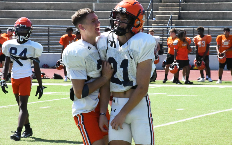 Senior Carter Barrett shows plenty of leadership for the Raiders off the field as well. Above, he congratulates Landyn Savage for a hit that knocked an opponent’s helmet off.  MATTHEW OSBORNE/Staff