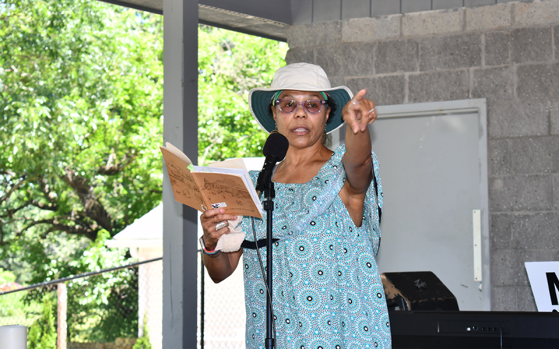 Dr. Doris Davenport points out an exact spot where events from her book of historical poetry took place while performing during the Juneteenth event Saturday. MATTHEW OSBORNE/Staff