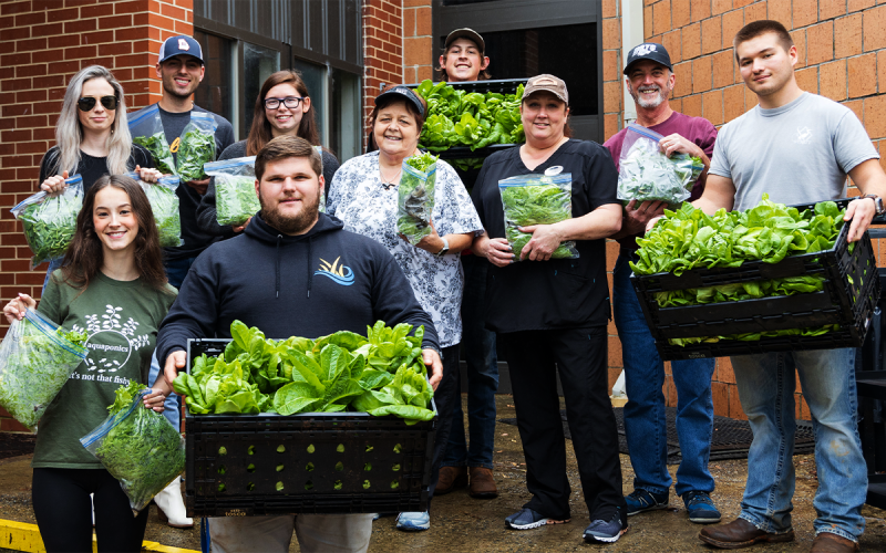 Students picked fresh lettuce used in the preparation of the meal for the ribbon cutting of the new facility. AMY HULSEY/Submitted