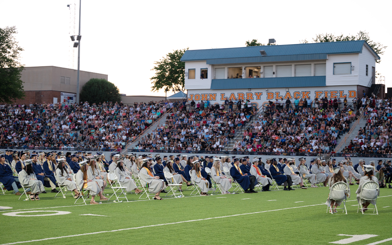 Habersham Central graduates listen to speakers with a big crowd of supporters behind them. ZACH TAYLOR/Special