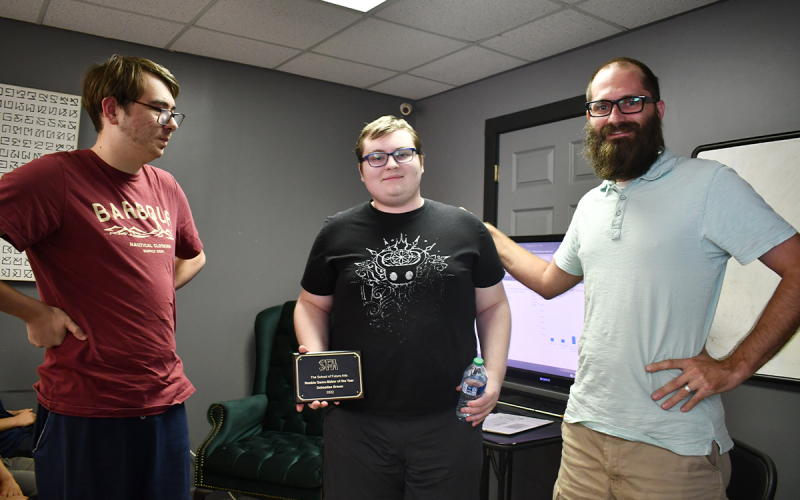 Owen Chitwood (left), last year’s Rookie Gamemaker of the Year, looks on as Sebastian Brown (center) receives the  2022 award from School of Future Arts Headmaster Justin Freeman. BRIAN WELLMEIER/Staff