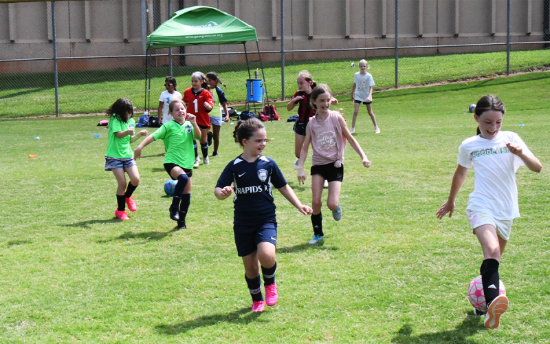Young players try to avoid getting clipped with the ball while running through a drill during camp. MATTHEW  OSBORNE/Staff