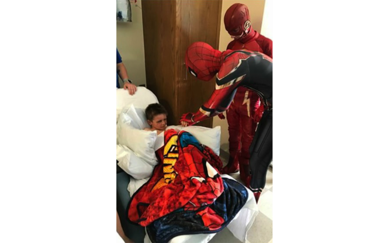 Spider-Man (Rylan Pugh) and Flash (Logan Hill) visit a young man in the hospital to raise his spirits. JOSH BRADY/Submitted