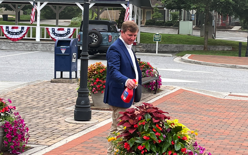Demorest Mayor Jerry Harkness touches up flowers in town Thursday as the city prepares to host the biggest regional  Independence Day celebration on Monday. MATTHEW OSBORNE/Staff