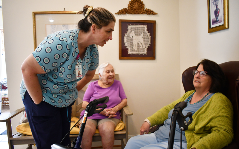 Elaina Ramirez interacts with Habersham Retreat resident Rebecca Carpenter as new resident Sarah Florence looks on. BRIAN  WELLMEIER/Staff
