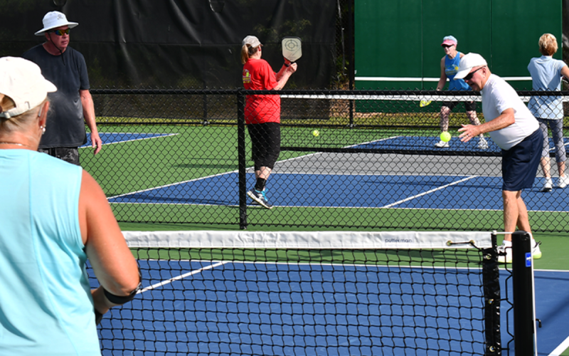 Bobby Gastley plays a ball with partner Kimble Johnakin as Debbie Flaherty waits on the other side of the net. MATTHEW OSBORNE/Staff