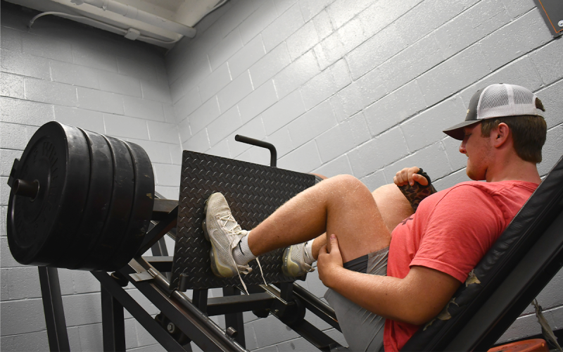 Dawson Barnett works the leg press while recovering from an arm injury. MATTHEW OSBORNE/Staff