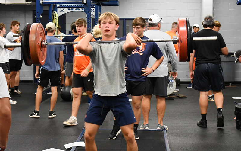 Raiders quarterback Carson Parker works the clean and jerk with his group. MATTHEW OSBORNE/Staff