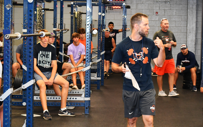 Strength coach Tip Johnson goes over the morning’s itinerary for weight training. MATTHEW OSBORNE/Staff