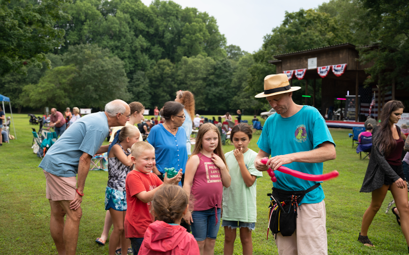Providing a group of kids with smiles, Mark Holmes creates amazing figures out of balloon animals. ZACH TAYLOR/Special