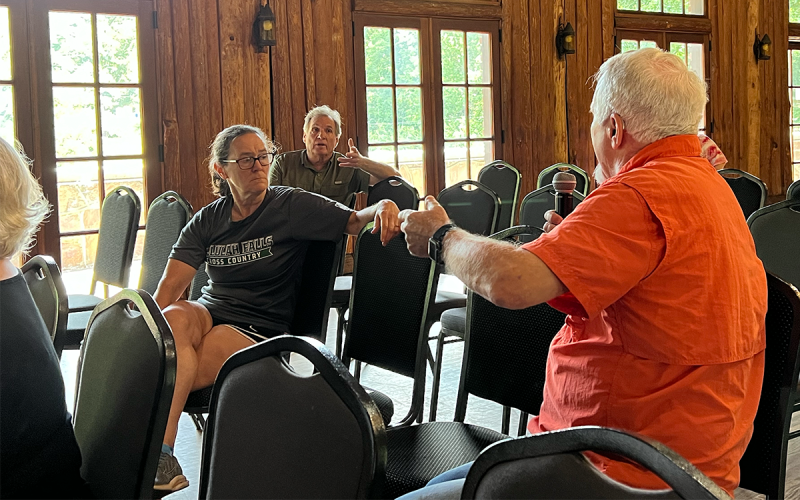 Residents Dennis Burkhalter and Jimmy Dean discuss the issue of a proposed Roads &amp; Bridges SPLOST at Tuesday’s town hall. BRIAN WELLMEIER/Staff
