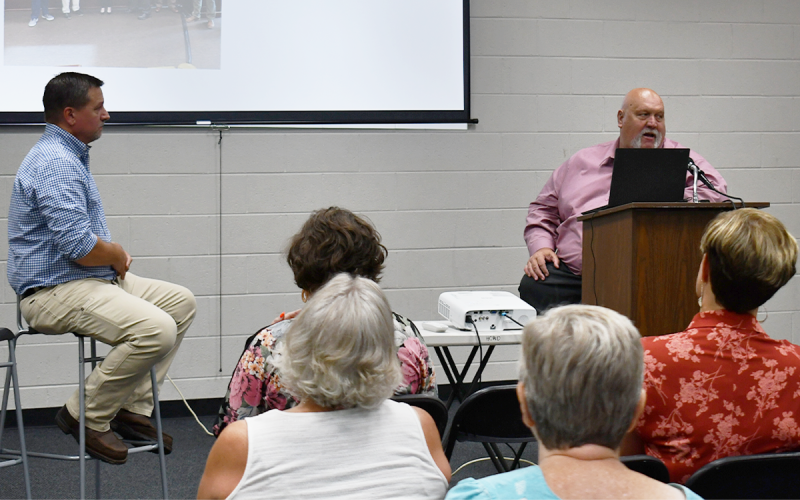 Commissioners Ty Akins and Bruce Palmer discuss economic development with the public at Wednesday’s town hall. BRIAN WELLMEIER/Staff