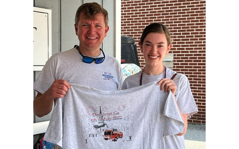 The designer of Demorest’s Fourth of July T-shirt is Claire Rogers, shown here with Mayor Jerry Harkness. Claire’s design included elements from the July 4 celebrations and incorporates the new fire truck as well as other Demorest downtown sites. KIM SIMONDS/Submitted
