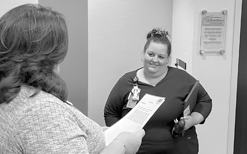 Marlana Kennedy listens as Nursing Director Valerie Lewis reads the nomination for the DAISY Award. MATTHEW OSBORNE/Staff