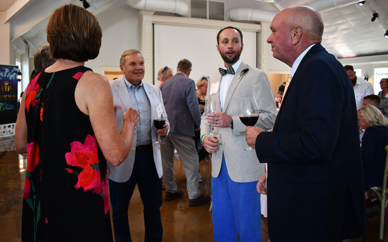 Clockwise from left, Melissa Williams, Dr. Stuart Sanders, Habersham Medical Center CEO  Tyler Williams and Stevie Williams converse at HMC’s fundraiser event Thursday night at Yonah Vineyard in White County. BRIAN WELLMEIER/Staff