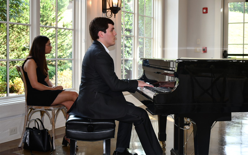 Sean VanMeter, concert pianist from Piedmont University, performs for the assembled guests. BRIAN WELLMEIER/Staff