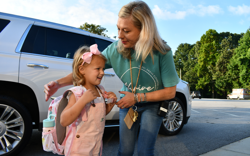 Hallie Hatchett is greeted by Assistant Principal Jennifer Porter at Hazel Grove Elementary on the first day of school. BRIAN WELLMEIER/Staff