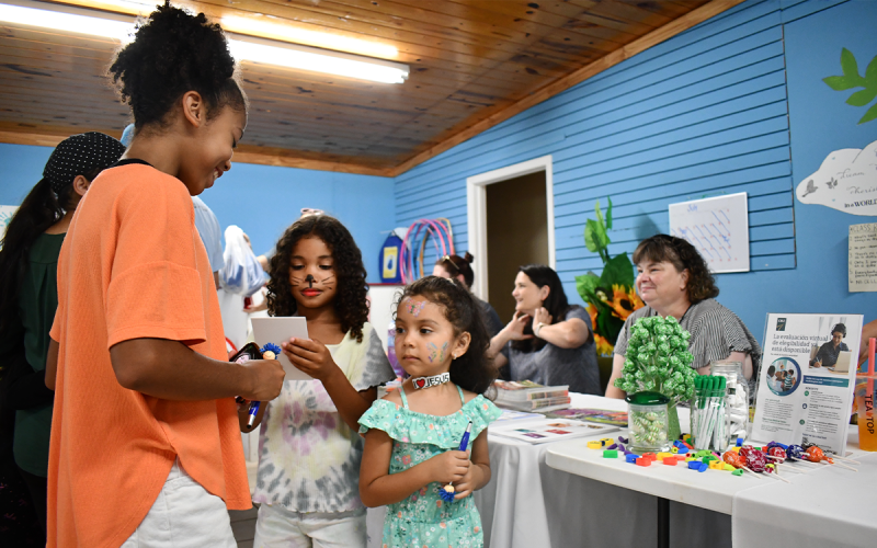 Charlotte Brown, Norah Brown and Genesis Ortiz attend the HMC health fair Saturday to help translate between residents and hospital staff. BRIAN WELLMEIER/Staff