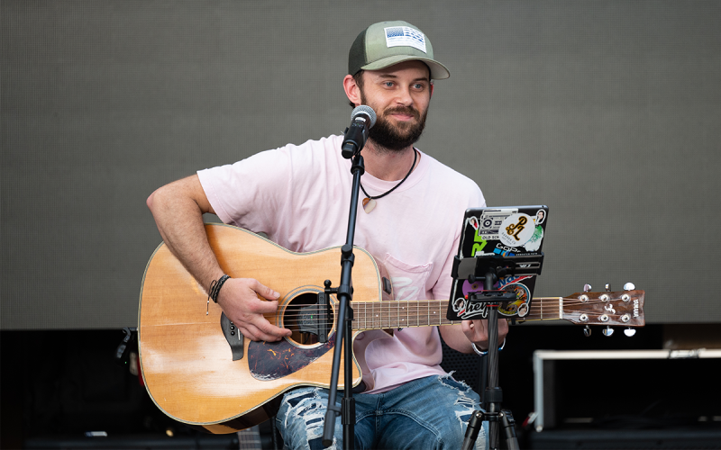 Solo artist and sound engineer Reece Watson smiles as he entertains folks in Fender’s Alley with country hits at Saturday night’s event. ZACH TAYLOR/Special