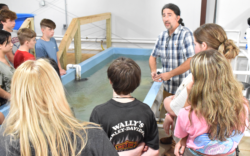 North Georgia Technical College Environmental Technology Instructor Duncan Hughes talks to a group of eighth-graders from North Habersham during their tour of the department on their “Color Tour.” AMARIS E. RODRIGUEZ/Staff