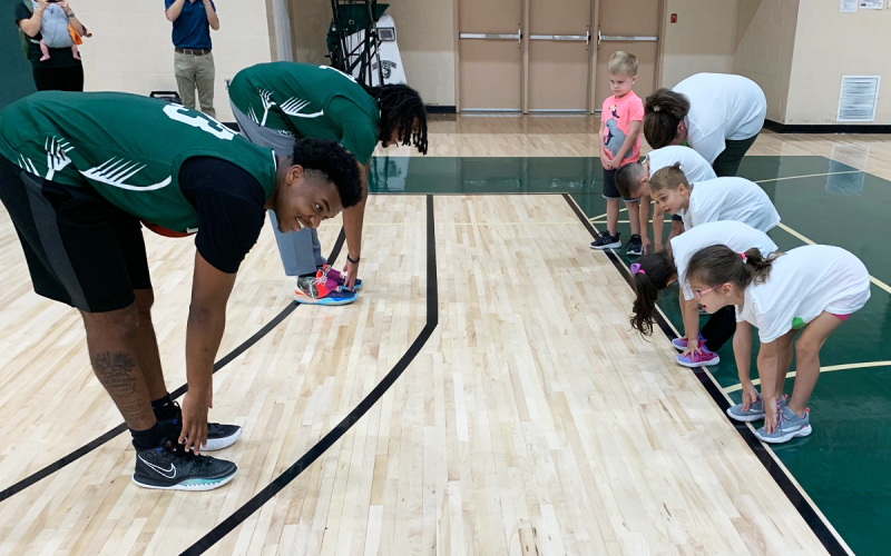Clements-Owens (back) and Logan Cranford (front) lead children from CFUMC Preschool in stretches, including Annabelle Carter, Bo McGahee, Sam Osborne, Jeremiah Garci and Nina Deputy. RACHEL PLEASANT/Submitted