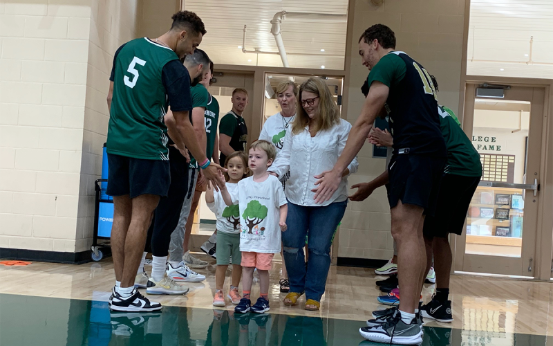 Members of Piedmont’s Men’s Basketball team formed two lines to greet children from CFUMC Preschool. RACHEL PLEASANT/Submitted