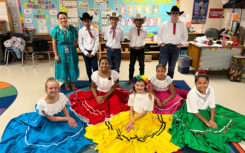 Baldwin Elementary Fifth-graders (left to right) Avery Peyton, Aria Rivera, Annaleigh Irvin, Abby Delgado, Sofia Leyva, Johan Maldonado, John Delgado, Aldo Flores Navarro, Isaiah McAllister, and their music teacher Analilia Gowan rehearsed for over a month to prepare for the Hispanic Heritage Month Celebration on Saturday. Not pictured: Hudson Garrett. AMARIS E. RODRIGUEZ/Staff