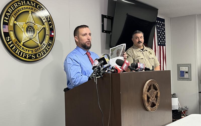 Habersham County Sheriff’s Investigator George Cason shows a picture of Deborrah Collier’s car captured by the  Tallulah Falls school zone cameras as Col. Murray Kogod (right) observes. MATTHEW OSBORNE/Staff