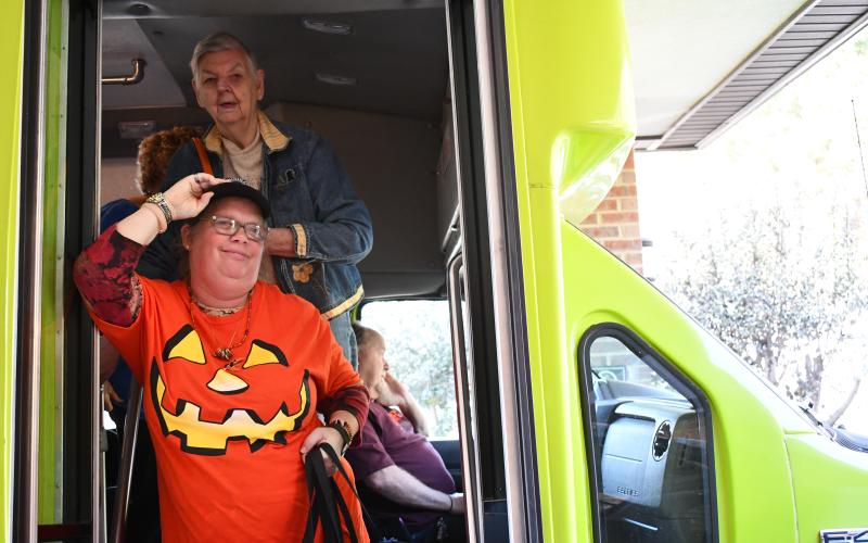 Joy Burrell and Helen Dove get off the Habersham County Senior Center’s new transit bus with a smile. JOHN DILLS/Staff