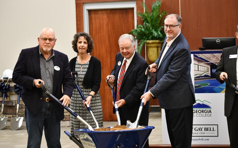 Mitchel Barrett, Eleanor Ivester, John Wilkinson and Cliff Bradshaw dig in to mark the start of the new building at NGTC on Thursday. JOHN DILLS/Staff