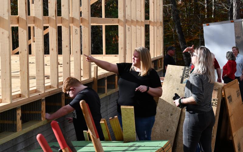 Jennifer Payne and her son Caleb show friends how things are looking for their future home in Demorest. MATTHEW OSBORNE/Staff