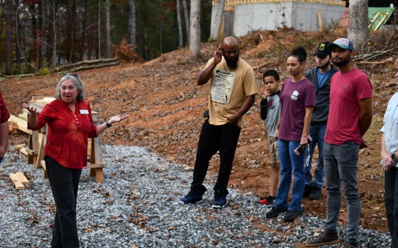 Executive Director Nanette Baughman speaks to the group while the Conner family looks on. The Conners will be in the house behind them on the hill. MATTHEW OSBORNE/Staff