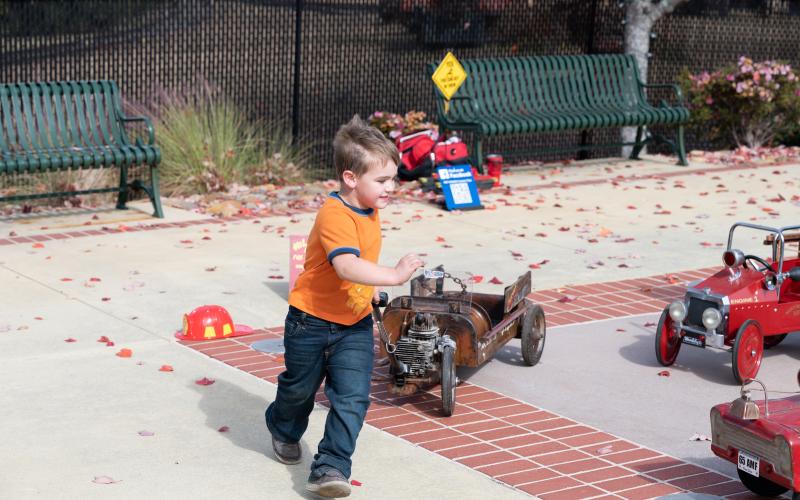 Levi Palmer runs around Cornelia Train Depot’s Splash Pad with a rat rod wagon provided by Russel Edge at Rat Wagon Custom Toys. ZACH TAYLOR/Special