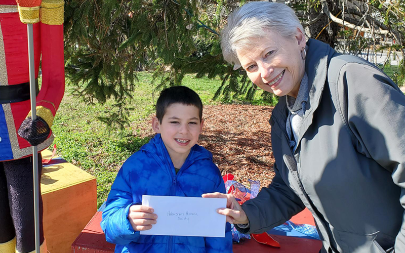 Liam Dyer is shown giving a check for $375 to Claudia Jessup, President of the Habersham Humane Society. CLAUDIA JESSUP/Submitted